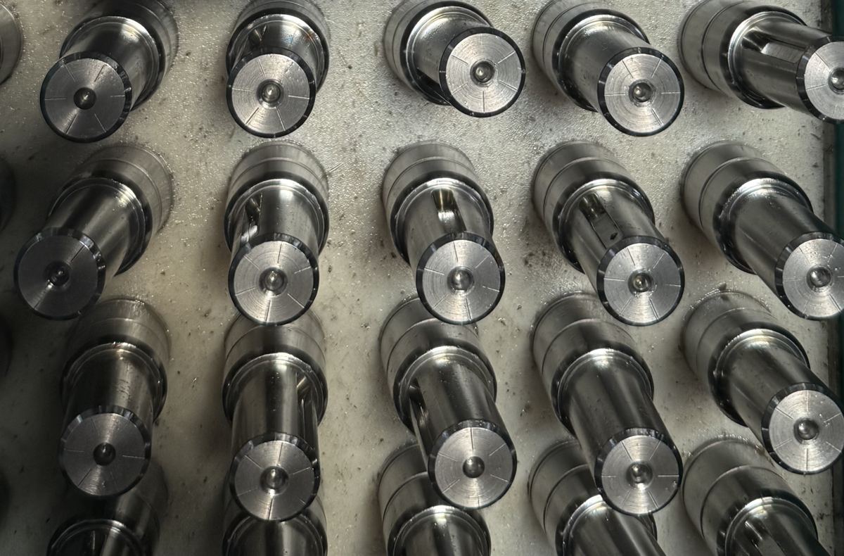 Shafts loaded upright on a jig, ready to be charged into the furnace.