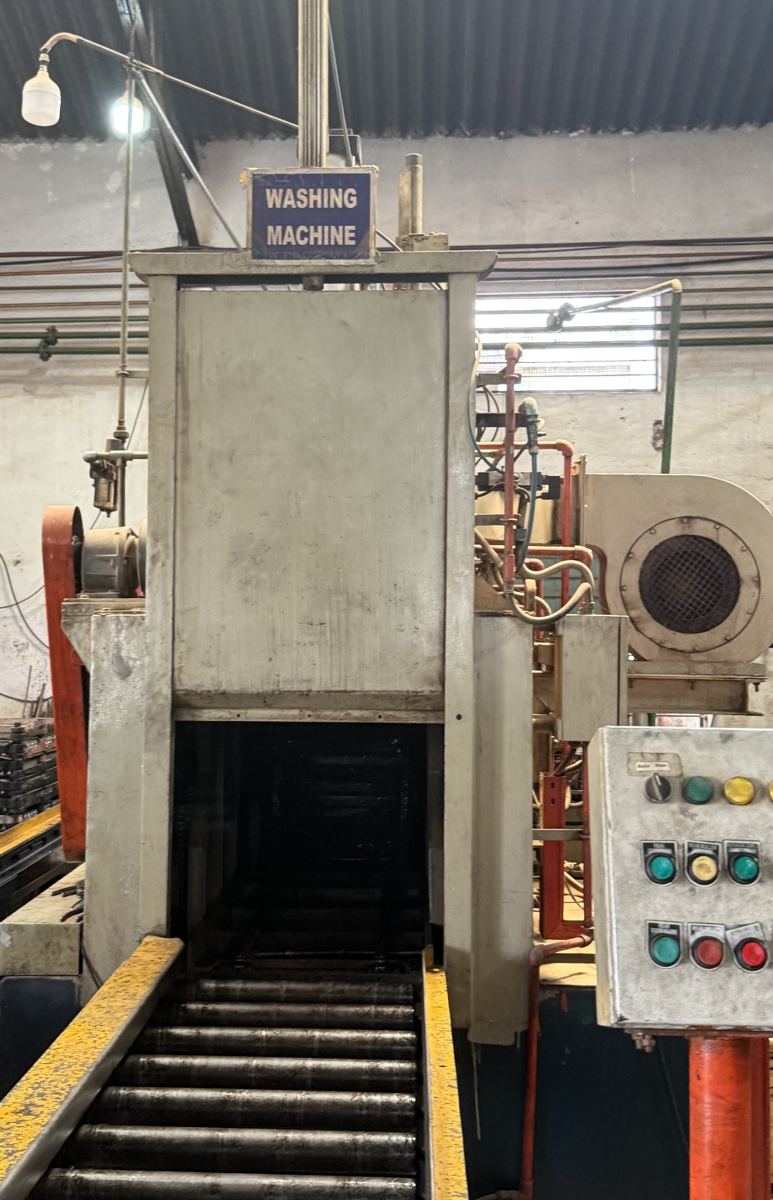 Conveyor washing machine used to clean parts before and after hardening.