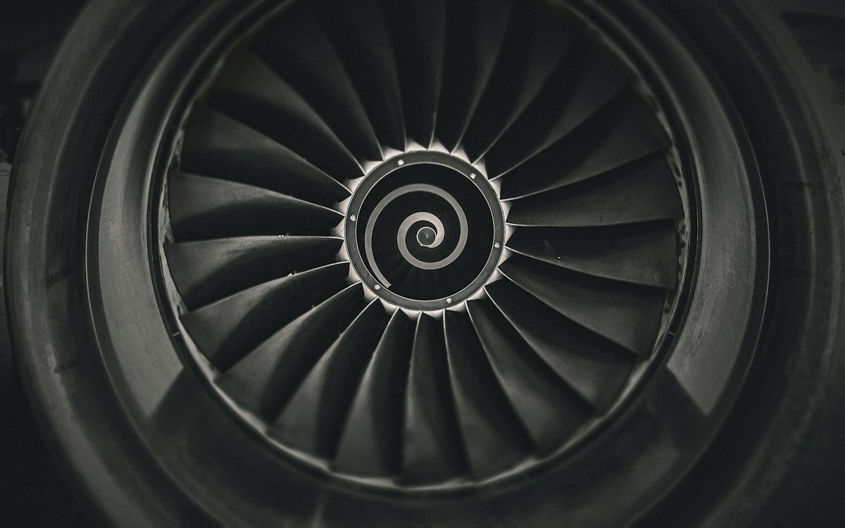 Black and white view into the fan of a jet engine.